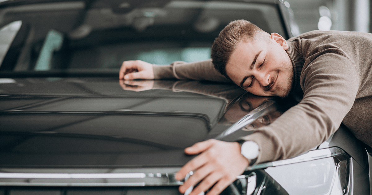 a man hugging a car symbolising upsides of used car loan