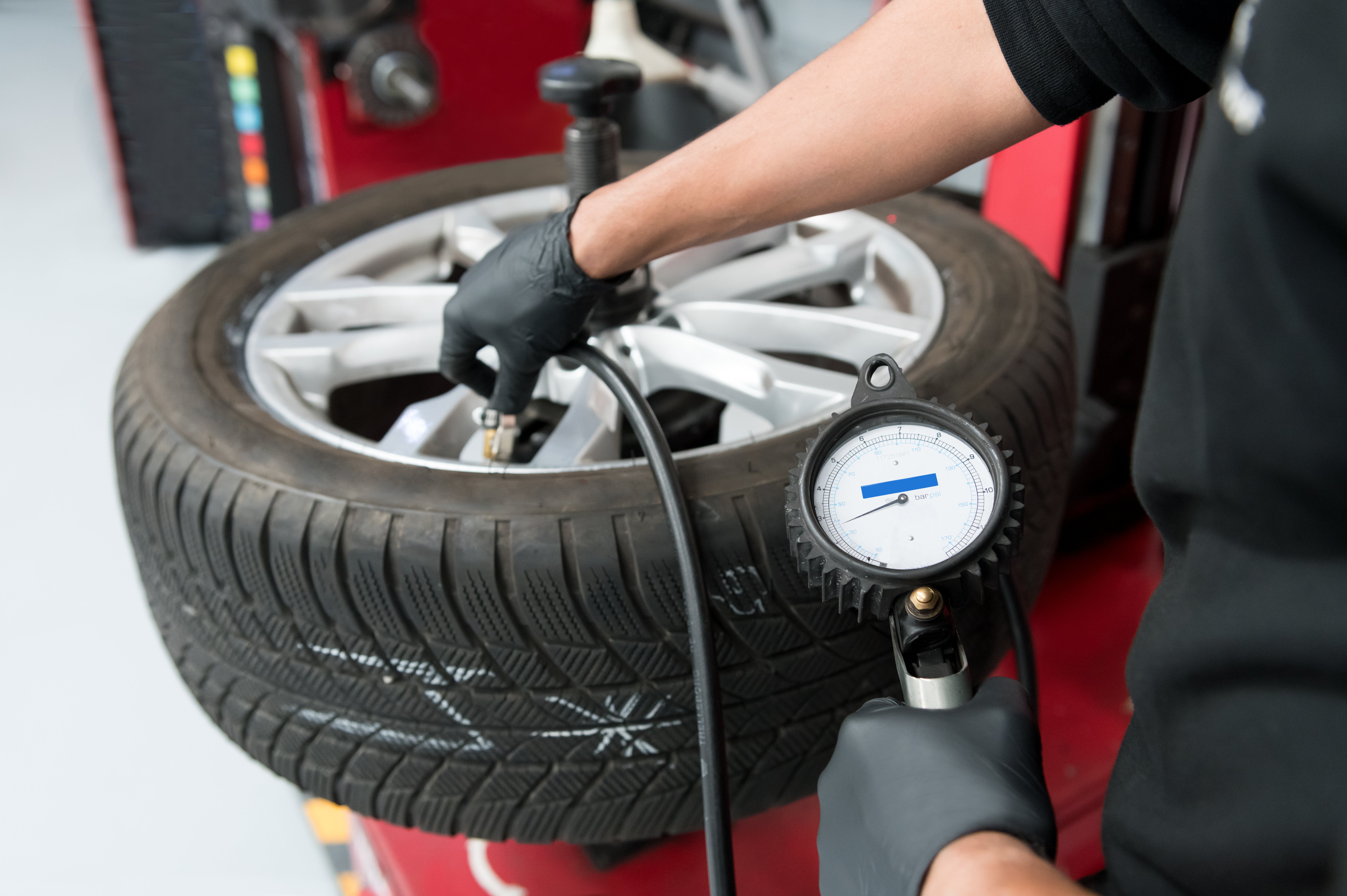 crop-mechanic-pumping-up-car-tire-workshop