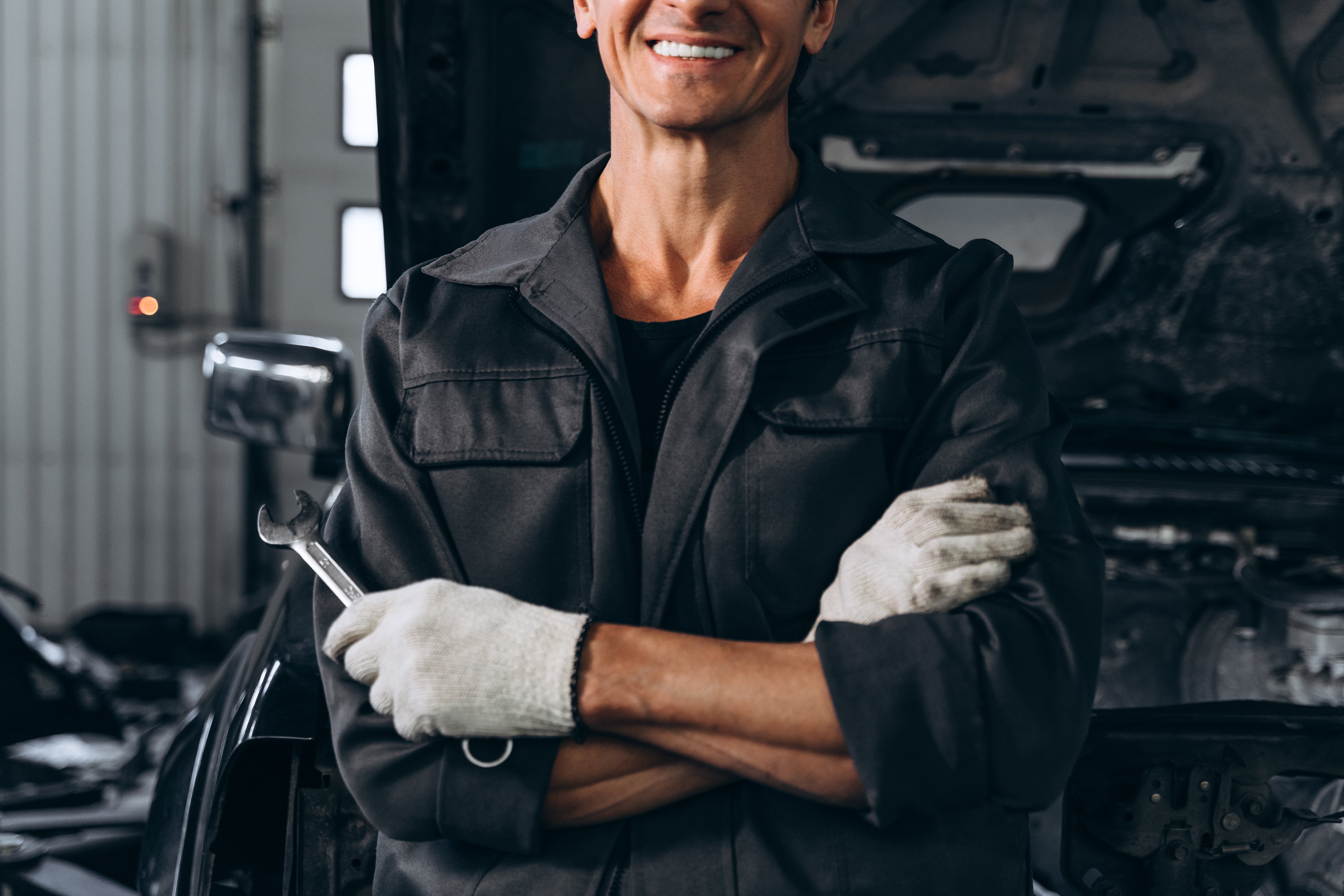 cropped-view-auto-mechanic-standing-near-opened-car-outdoors-holding-wrench-car-repair-concept