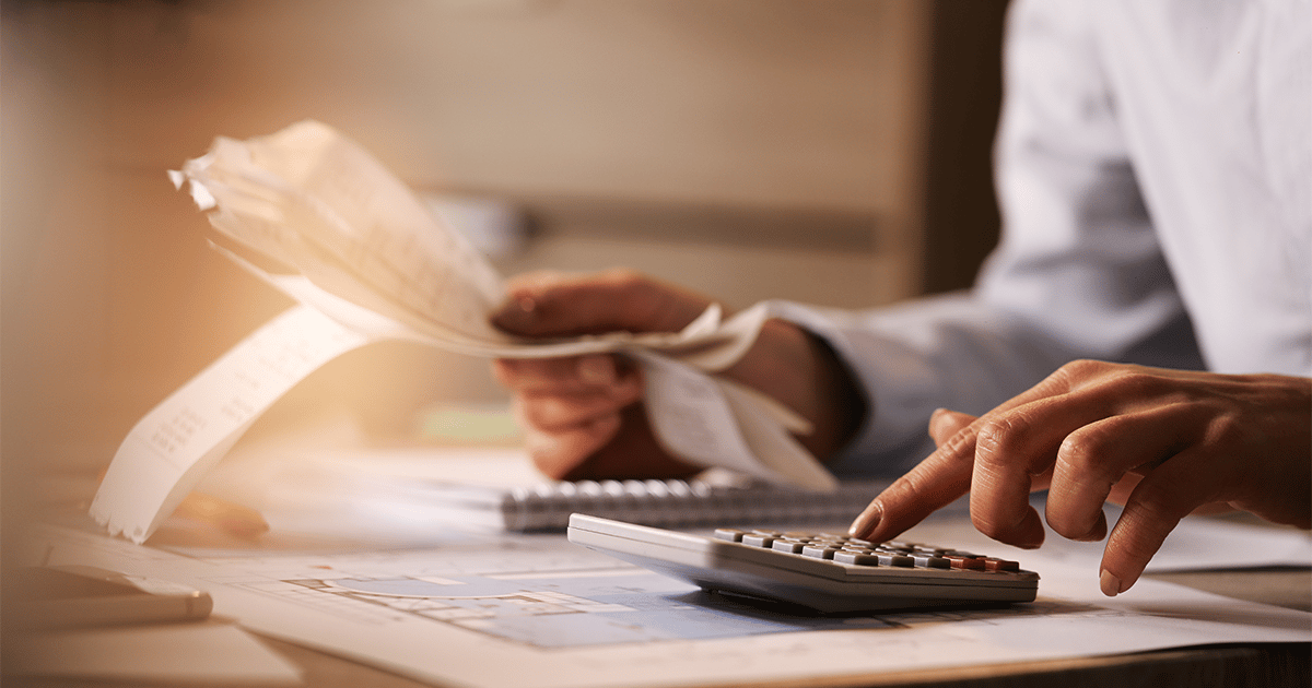 man calculating debt with calculator