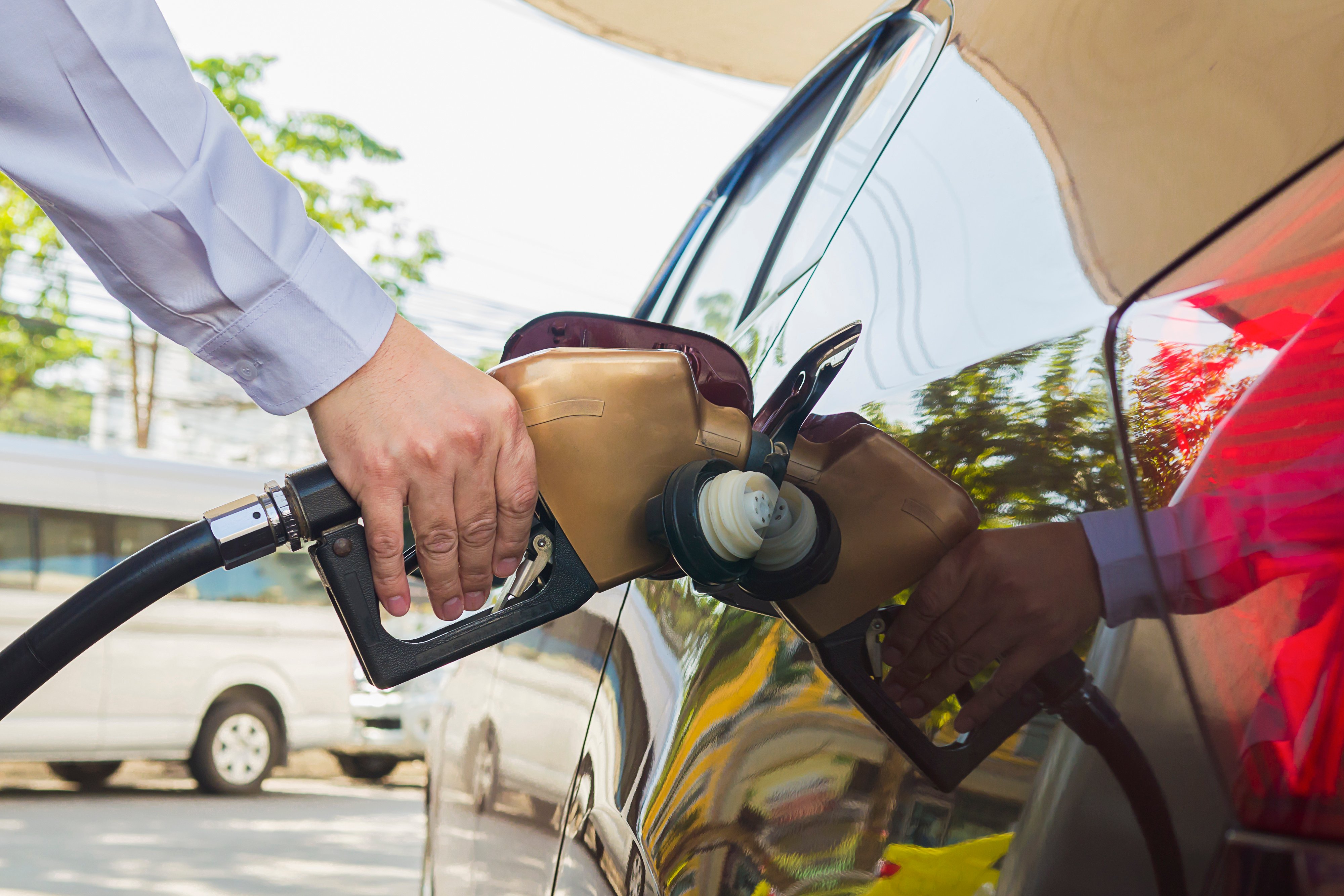 man-putting-gasoline-fuel-into-his-car-pump-gas-station