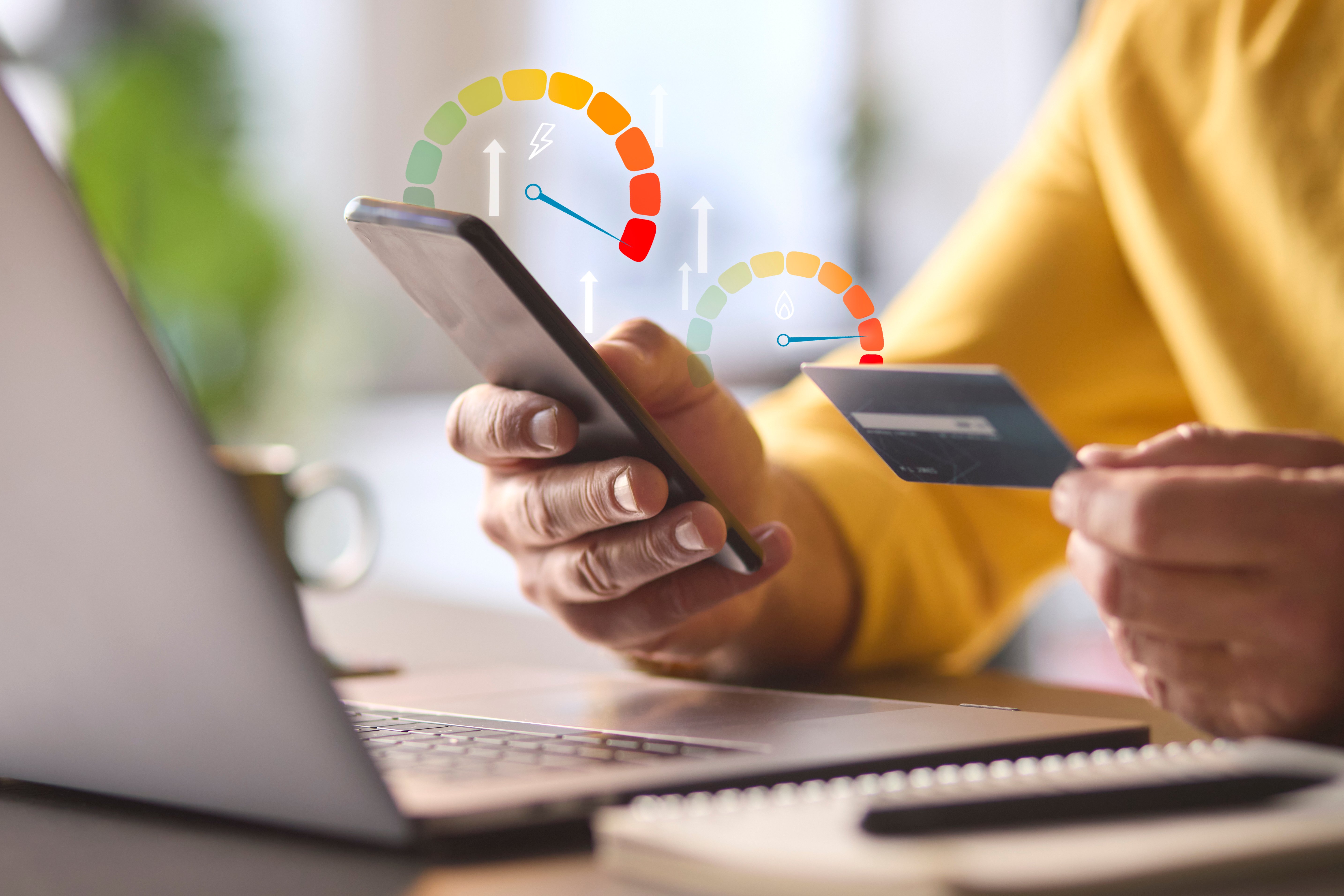 man-using-mobile-phone-app-with-graphic-overlay-showing-energy-consumption-credit-card