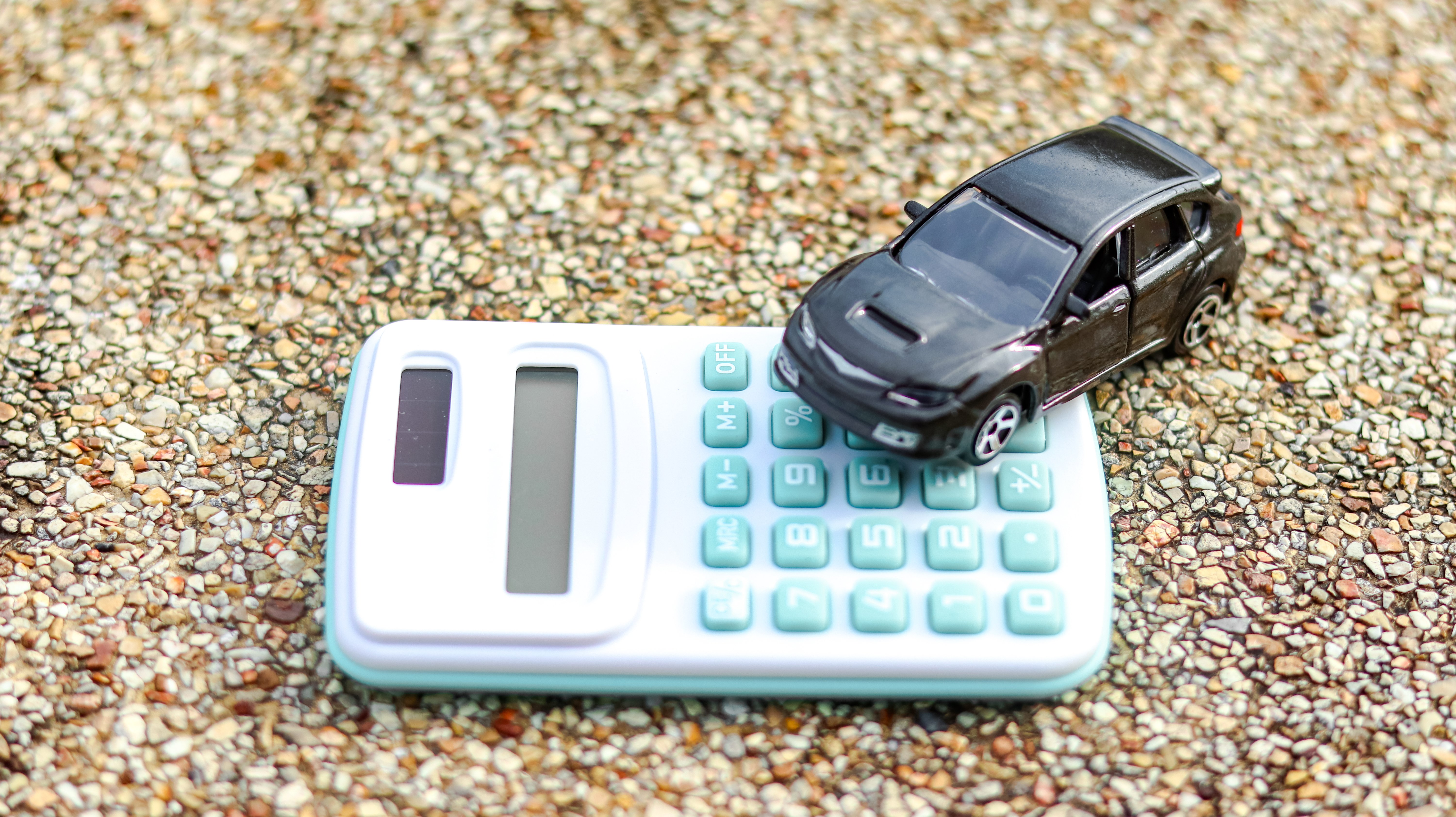 model-car-calculator-are-exposed-aggregate-concrete-background