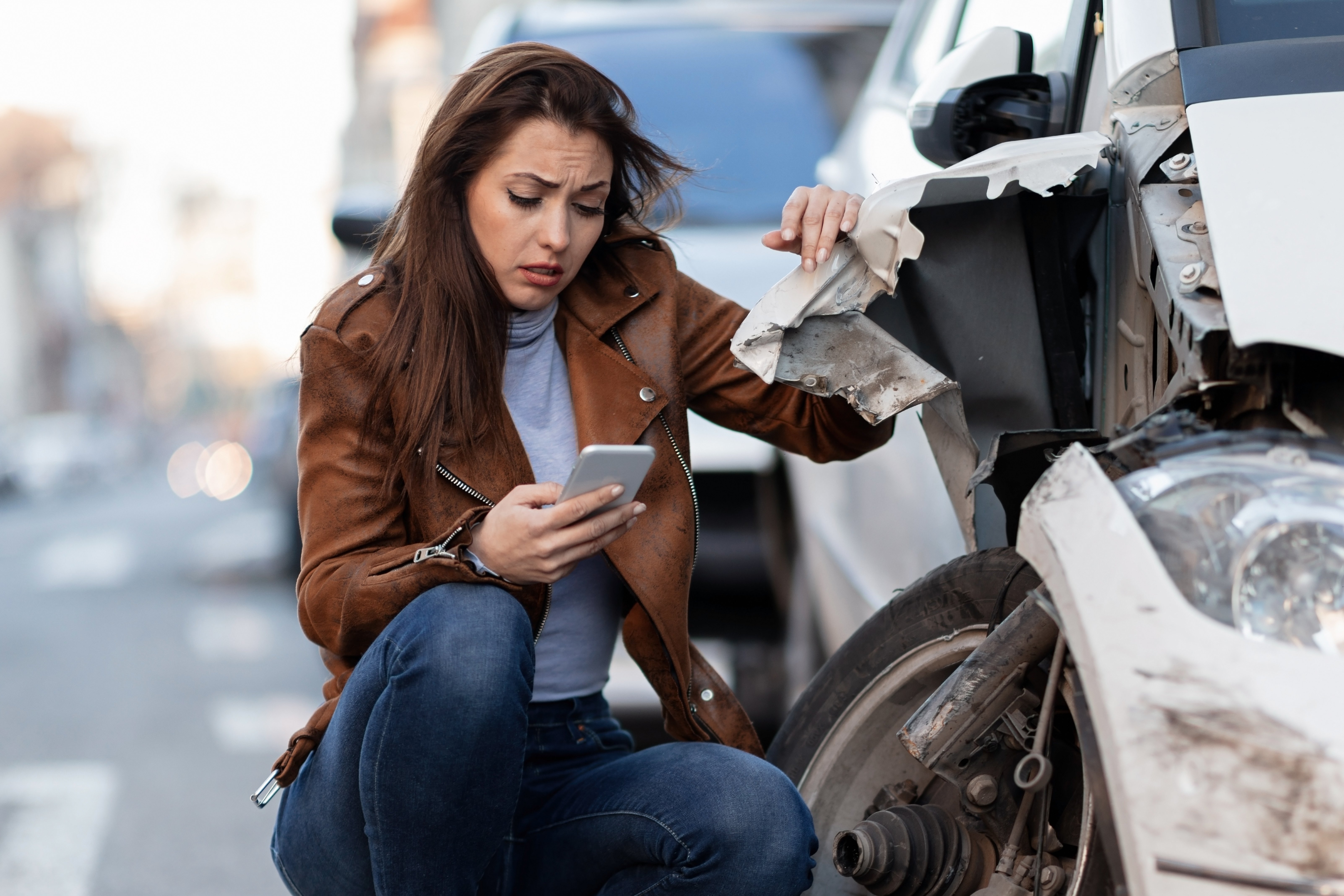 young-sad-woman-text-messaging-smart-after-car-crash-road